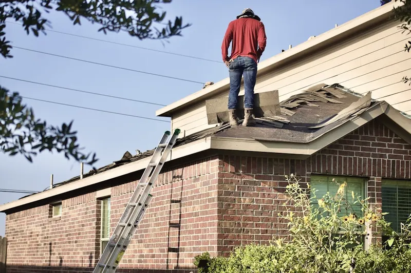 Professional roofer working on a residential roof in Brentwood Hills